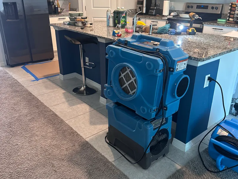 Blue drying equipment staged during post-storm interior mitigation