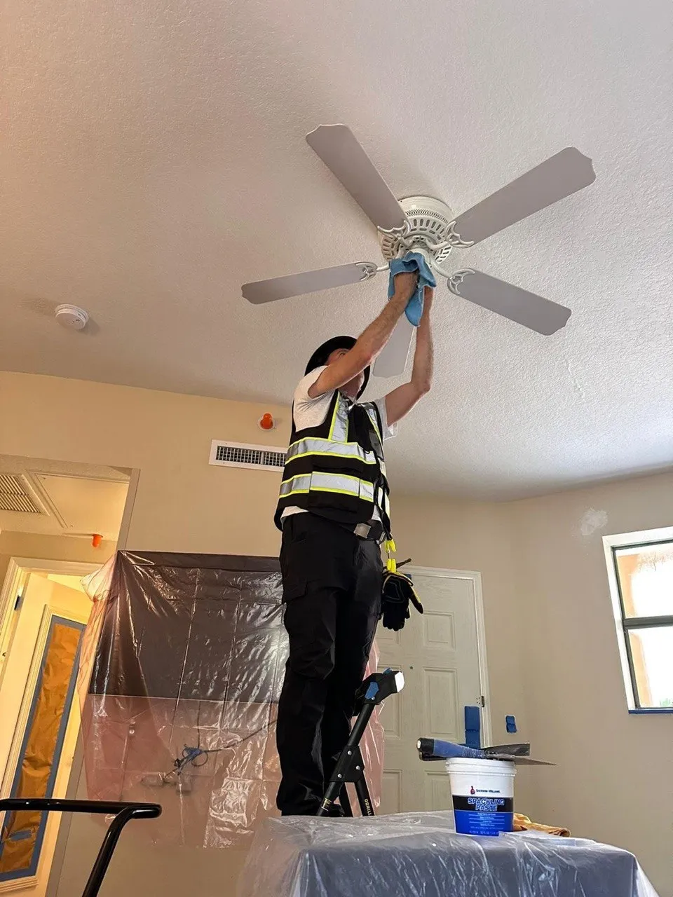 Commercial cleaning technician handling interior detail work during a property reset