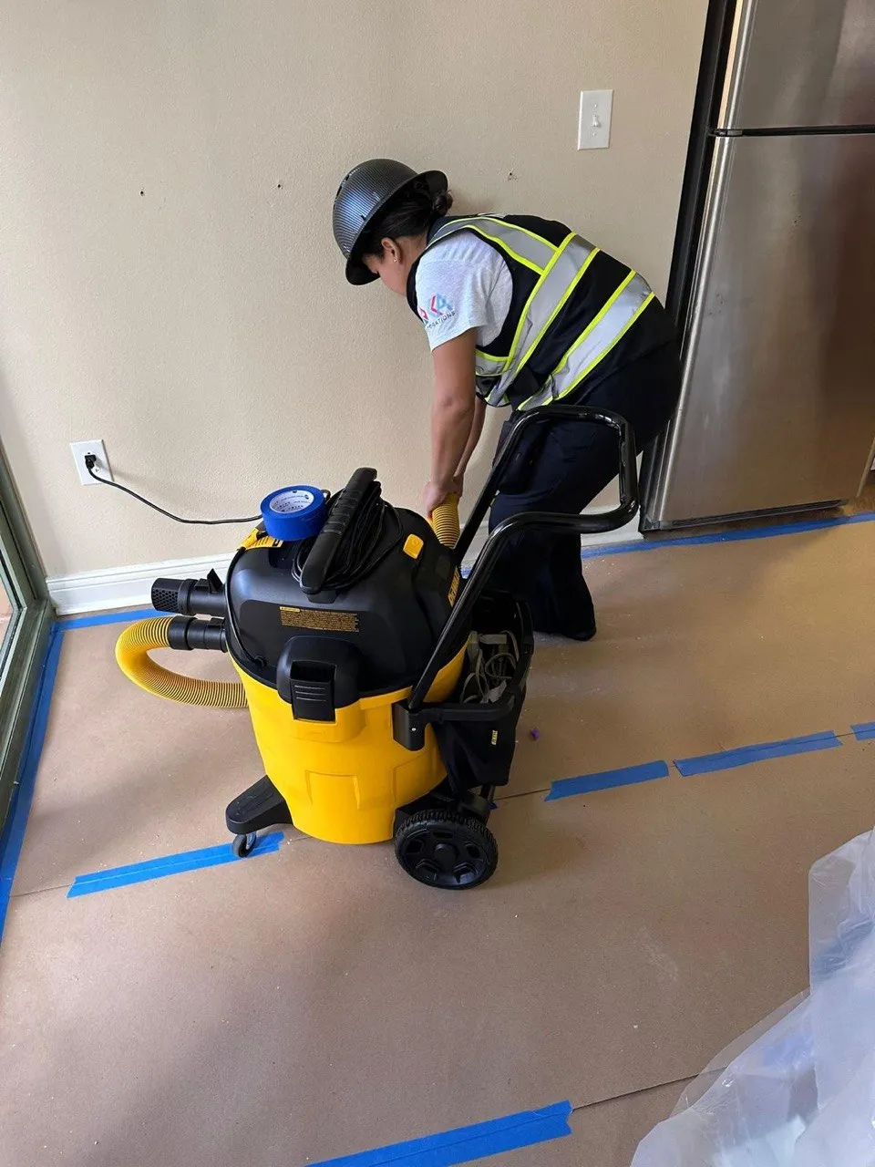 Commercial cleaning technician working around protected interior flooring