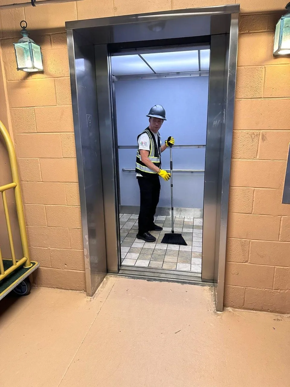 Commercial cleaning technician servicing an elevator area