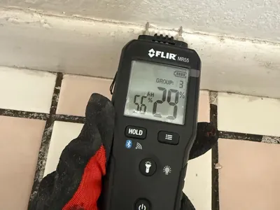 Moisture meter reading taken during emergency water extraction and controlled drying