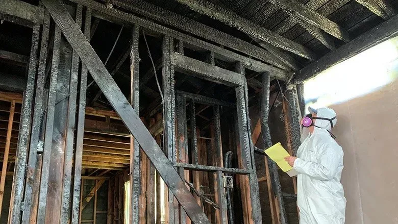 Technician assessing interior fire and smoke damage